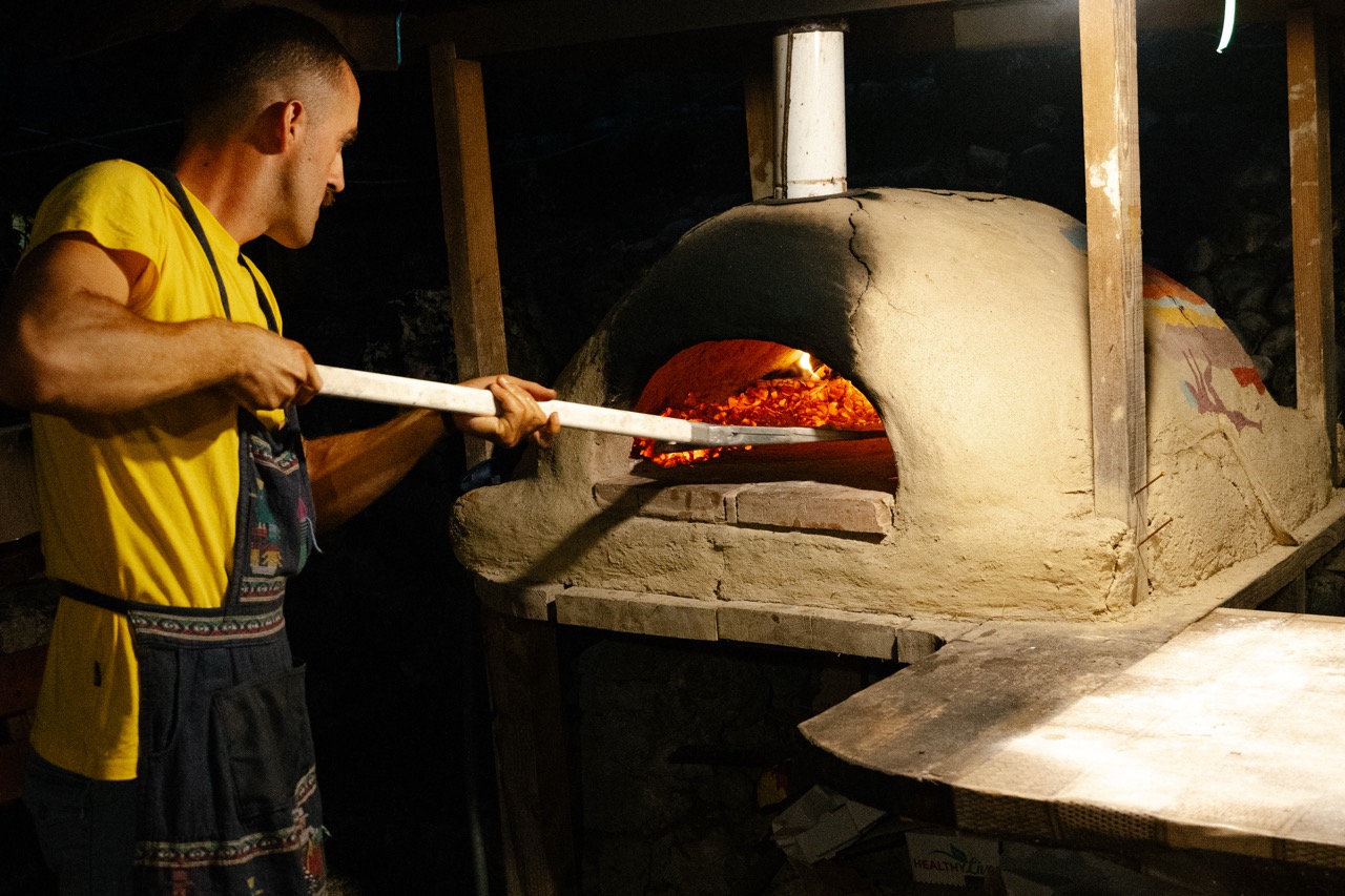 Pizza baking in the wood-fired oven